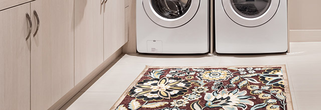 Floral area rug in laundry room.