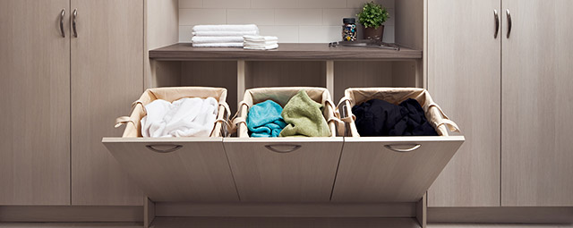 Multiple laundry hampers to sort clothes by colour from Organized Interiors.