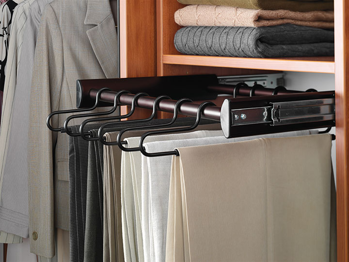 beige white and dark pants hung o rack in closet disorganized closets pant rack