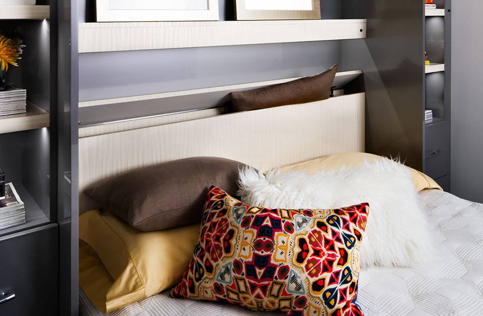 Hidden wall bed storage for pillows and blankets.