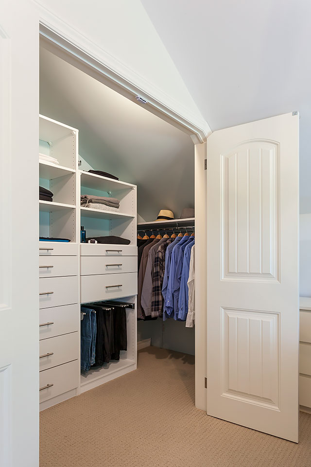 Custom bedroom closet with doors open.