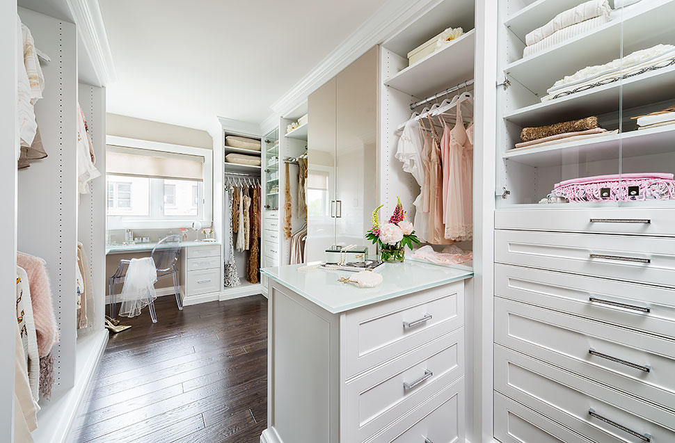 White dressing room walk-in closet with plenty or storage.