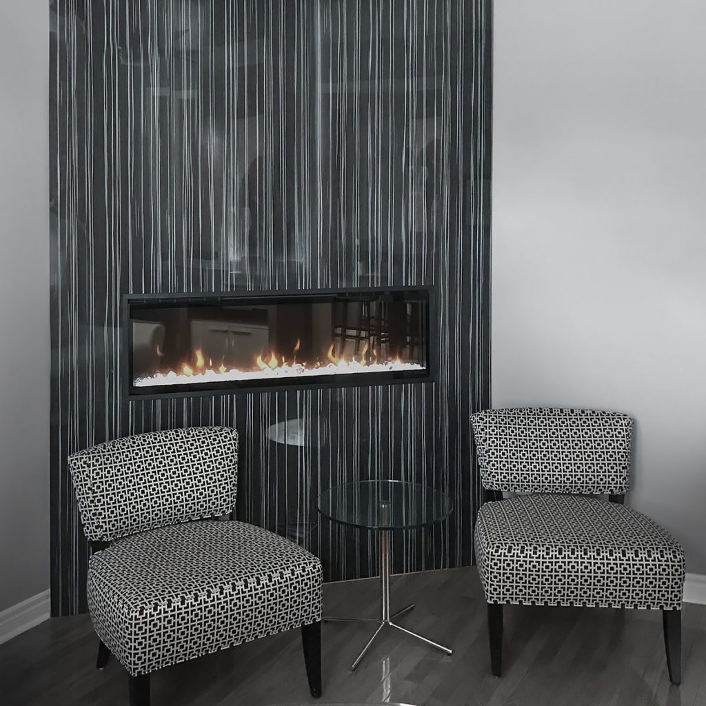 electric fireplaces feature wall two chairs and glass table