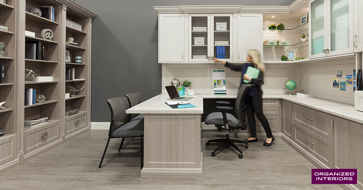 Woman in a home office designed by Organized Interiors.