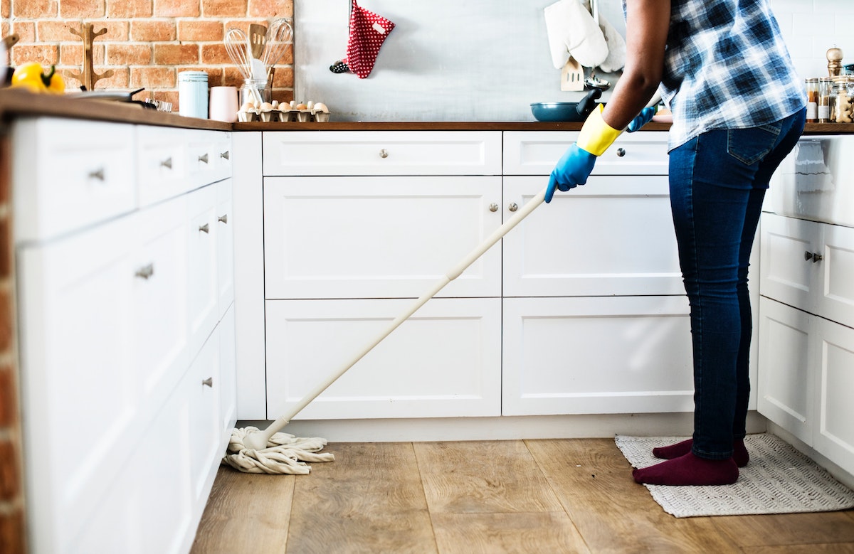 home air quality woman mopping in kitchen