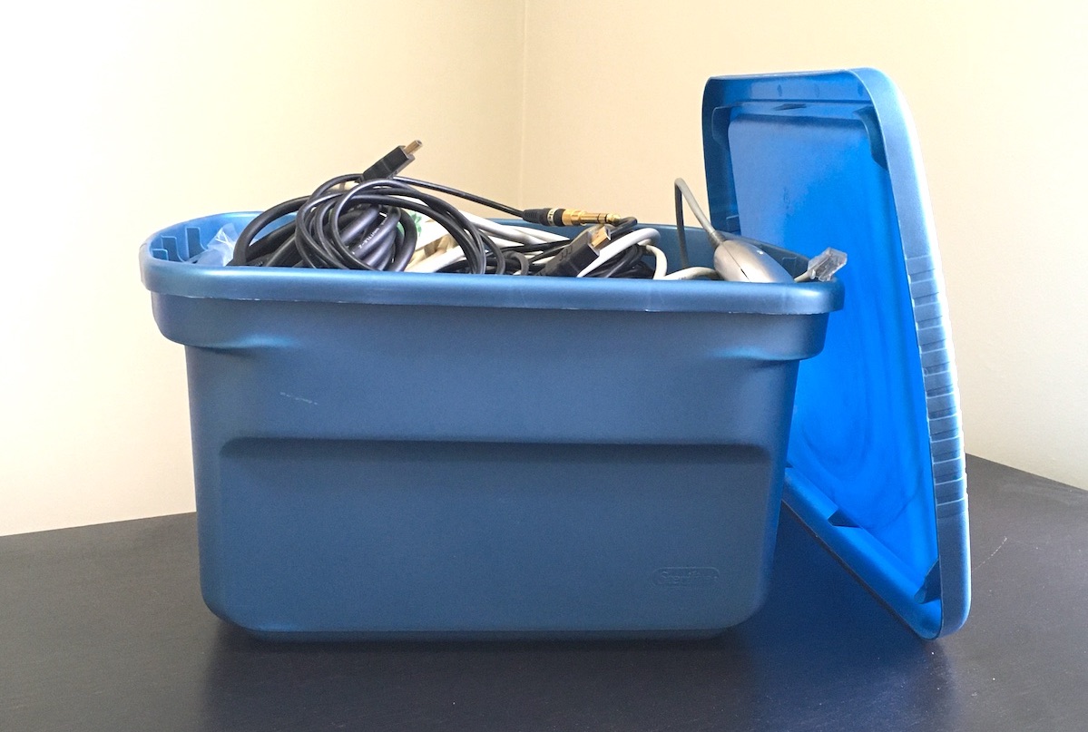 plastic storage container with wires and cables