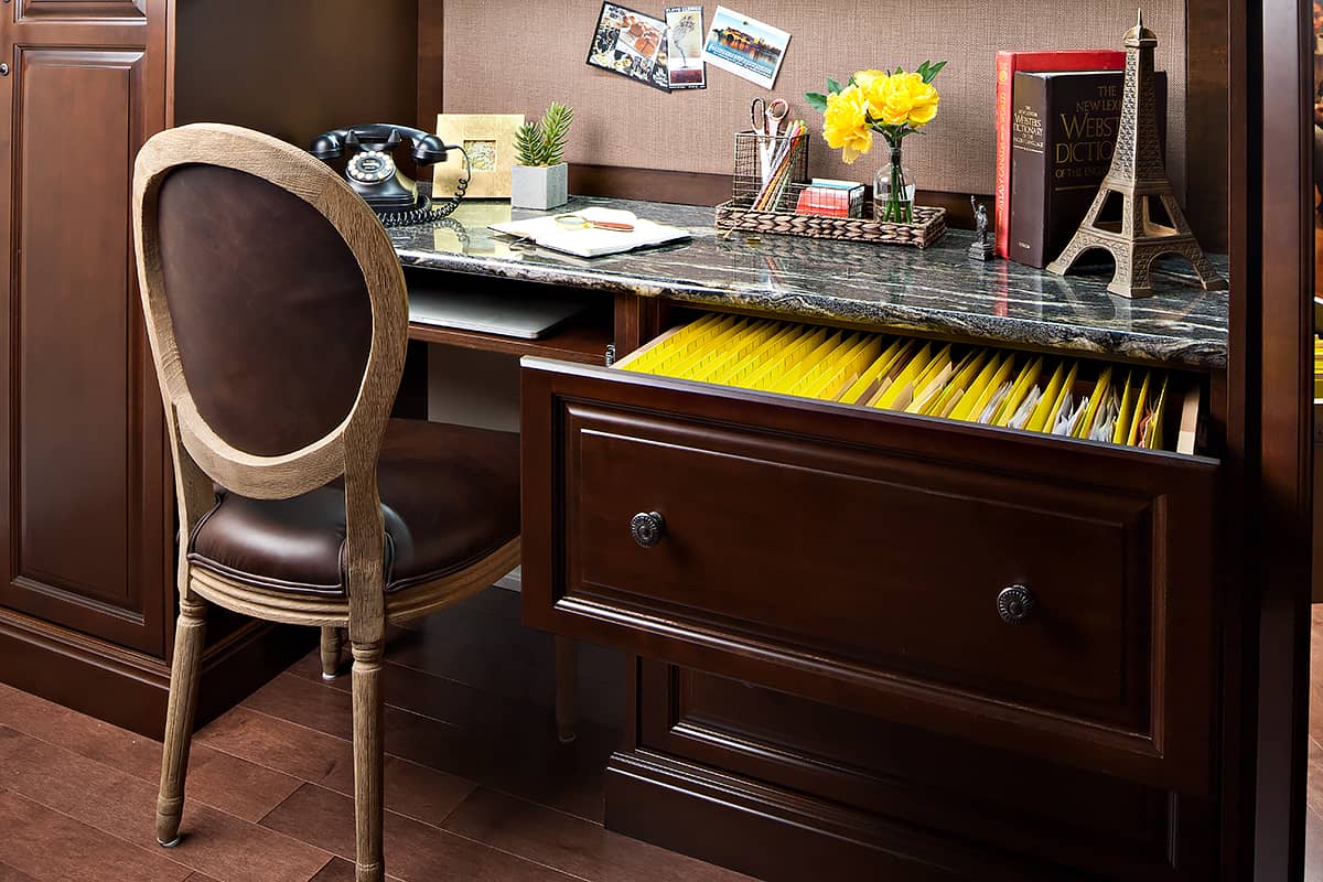 dark desk and cabinetry for home office and single chair