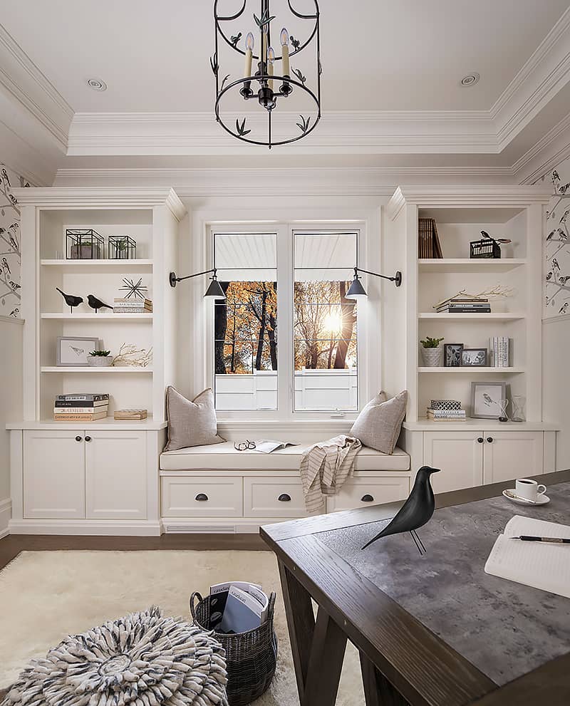 cozy home den with white built-ins and window seat
