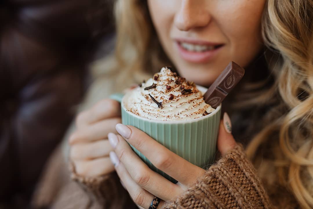 woman holding warm beverage