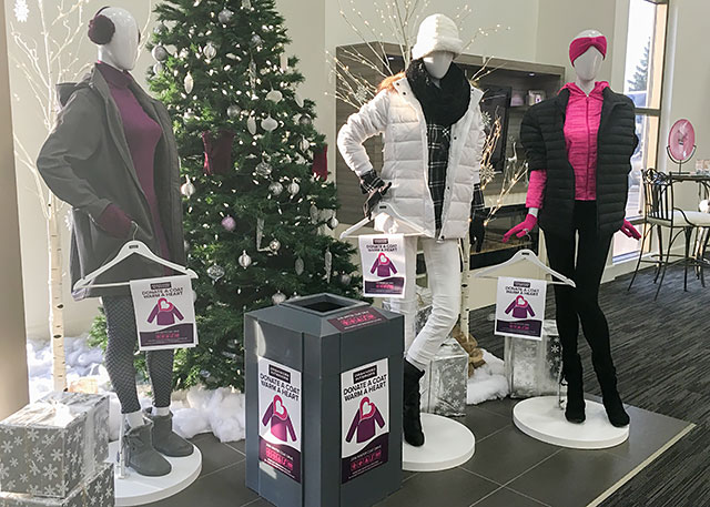 Coat donation box display in Organized Interiors showroom.