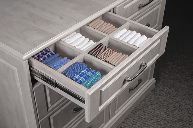 Drawer dividers in a woman's closet.