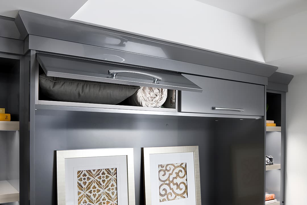 built-in storage above headboard with a gray finish