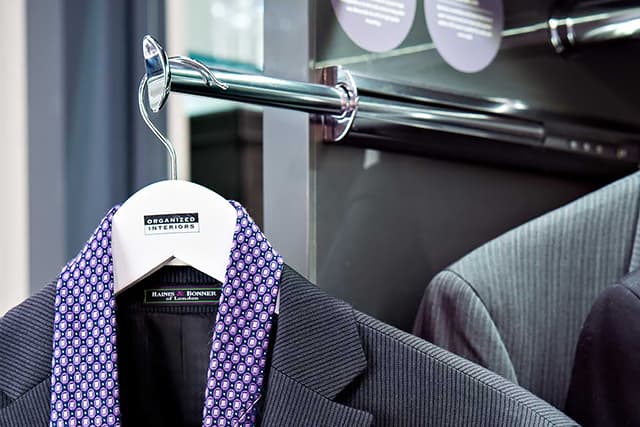 Valet rod hanging a summer dress in a closet